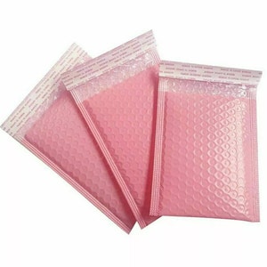 May include: Three pink bubble mailers with self-adhesive closures. The mailers are made of a durable, flexible material with a textured bubble lining for added protection.