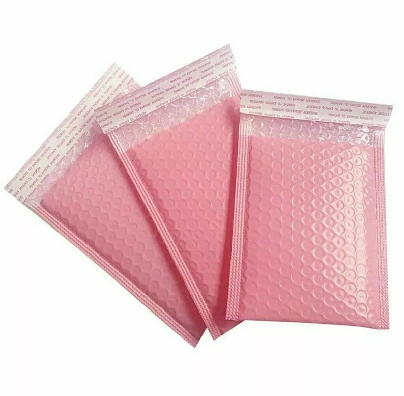 May include: Three pink bubble mailers with self-adhesive closures. The mailers are made of a durable, flexible material with a textured bubble lining for added protection.