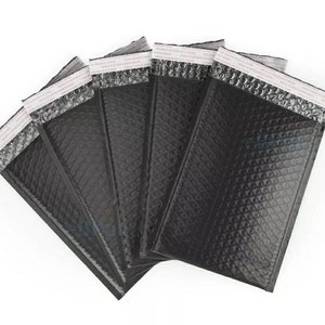 May include: Five black padded mailing envelopes with a silver bubble pattern and white adhesive strips.