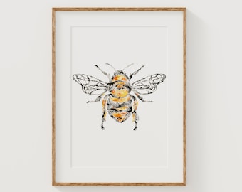 May include: A framed art print featuring a watercolor illustration of a bee. The bee has a yellow and black body with detailed wings. The artwork is set against a white background, and the frame is a natural wood color.