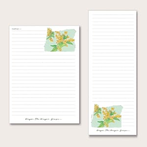 May include: A lined notepad with a green outline of the state of Oregon with yellow flowers. The text "Oregon: The Oregon Grape" is at the bottom of the notepad.