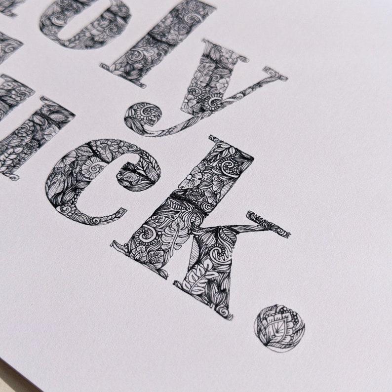 May include: A close-up of the word "lucky" written in a decorative font. Each letter is filled with intricate black and white patterns.