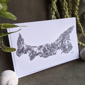 May include: A black and white line drawing of Prince Edward Island, Canada, with a detailed, intricate design of swirling patterns and foliage.