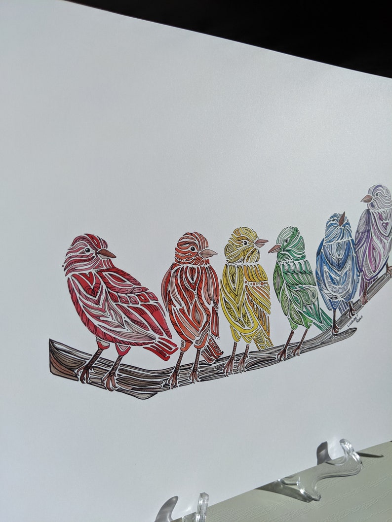 May include: A colorful illustration of six birds perched on a branch. The birds are arranged in a rainbow pattern, with red, orange, yellow, green, blue, and purple birds. The birds are drawn in a detailed, intricate style, with each feather and wing carefully rendered.