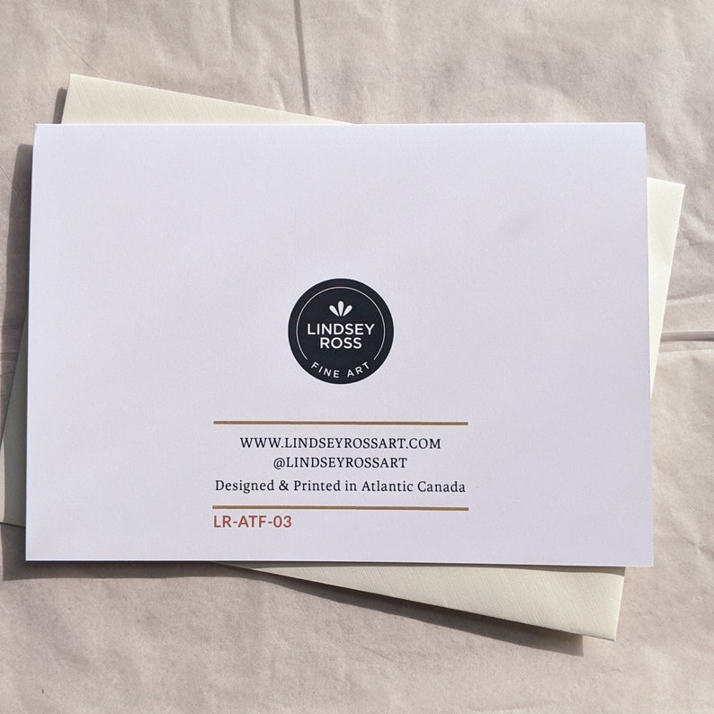 May include: A white card with black text and a black logo that says "Lindsey Ross Fine Art". The text on the card reads "www.lindseyrossart.com @lindseyrossart Designed & Printed in Atlantic Canada LR-ATF-03"