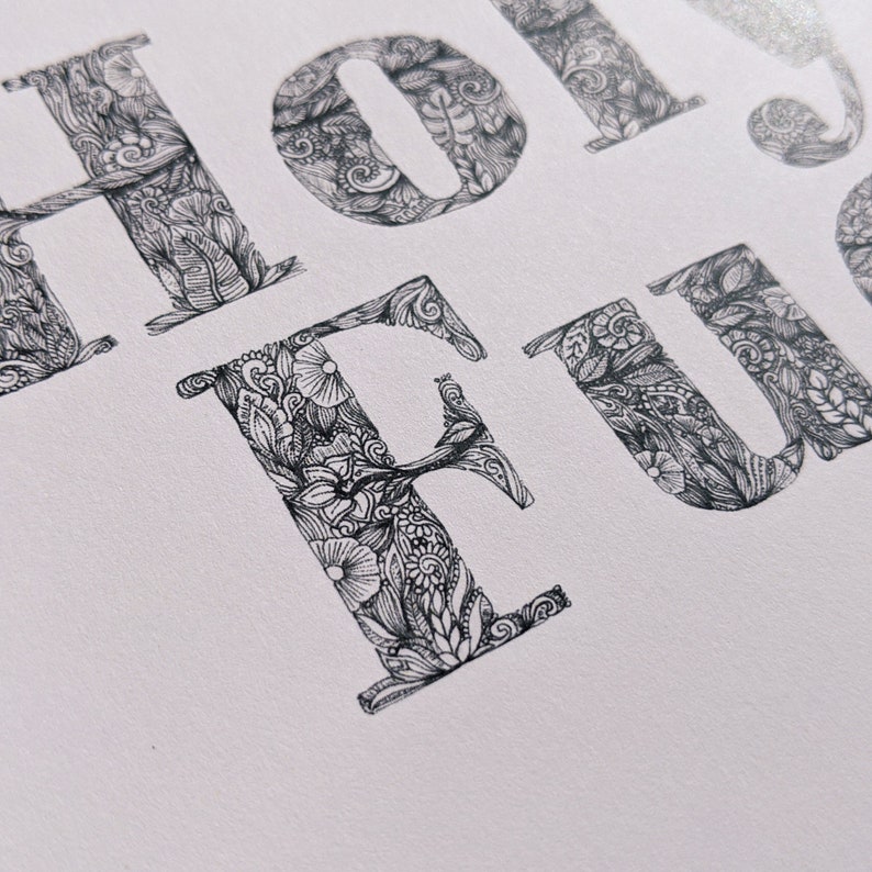 May include: A black and white illustration of the word "HOLIDAY FUN" with intricate floral and doodle designs.