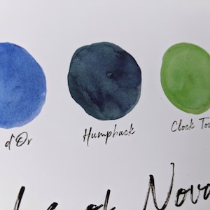 May include: Three watercolour swatches on a white background. The swatches are labelled "d'Or", "Humpback", and "Clock Tower". The colours are a light blue, a dark blue-green, and a light green.