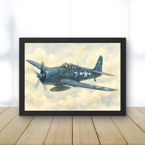 May include: A framed watercolor print of a blue World War II-era airplane in flight. The aircraft features a white star and the number 7. The background shows a cloudy sky with yellow and white hues. The frame is black.