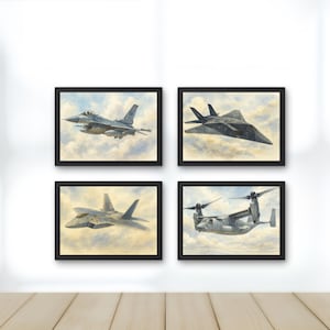 May include: A set of four framed wall art prints, each featuring a detailed watercolour illustration of a different military aircraft flying through a cloudy sky. The collection includes a fighter jet, a stealth aircraft, and a tiltrotor aircraft.