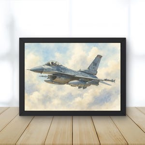 May include: A framed print showing a grey F-16 fighter jet in flight against a backdrop of clouds. The artwork features detailed depictions of the aircraft, including missiles and markings. The sky is rendered in soft, pastel colours.