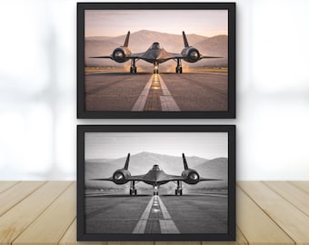 May include: Two framed prints featuring a black SR-71 Blackbird aircraft on a runway. One print is in color, showcasing the plane against a sunset backdrop. The other is a black and white version of the same image. Both are framed in black.