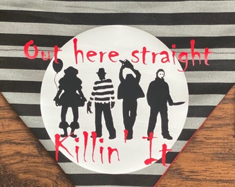May include: A black and gray striped dog bandana with a red trim. The bandana features a white circle with black silhouettes of horror movie characters and the text "Out here straight killin it" in red.