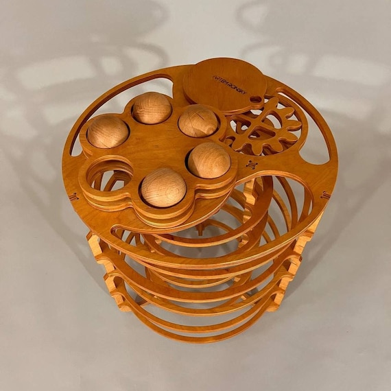 A hand-crafted Ukrainian wooden Coriolis rolling-ball sculpture that's genuinely one-of-a-kind artisan work — 77 favorites on a $780 piece says serious collectors are paying attention.