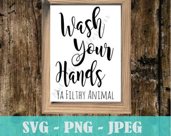 May include: A white sign with a wooden frame, featuring the text "Wash your hands Ya Filthy Animal" in black cursive font.