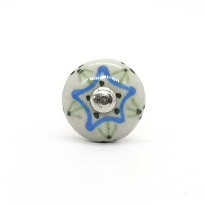 May include: White ceramic knob with a blue star design and green accents.