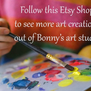 May include: A paintbrush with yellow paint on the bristles rests on a palette with various colours. The text reads "Follow this Etsy Shop to see more art creations out of Bonny's art studio."