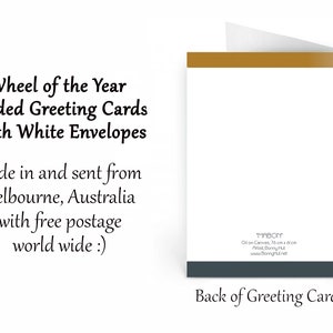 May include: A folded greeting card with a white interior and a gold-coloured top edge. The card's text reads "Wheel of the Year Folded Greeting Cards With White Envelopes." The back of the card has text and a dark grey border.