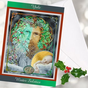 May include: A greeting card with a winter solstice theme. The card features an illustration of a bearded figure with a green and brown face, adorned with leaves and berries. The text "Yule" and "Winter Solstice" are displayed on the card. A white envelope and holly sprig are in the background.