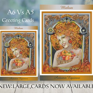 May include: Two greeting cards, A6 and A5 sizes, with a woman adorned with autumn leaves and a basket of fruit. The cards display the text "Mabon" and "Autumn Equinox". The larger card is labeled "NEW: LARGE CARDS NOW AVAILABLE."