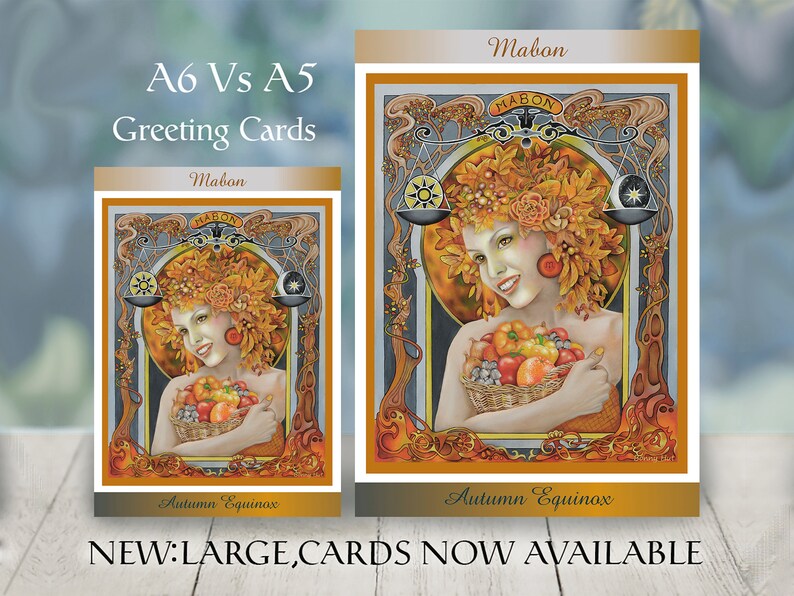 May include: Two greeting cards, A6 and A5 sizes, with a woman adorned with autumn leaves and a basket of fruit. The cards display the text "Mabon" and "Autumn Equinox". The larger card is labeled "NEW: LARGE CARDS NOW AVAILABLE."