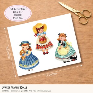 Puede incluir: Una hoja de papel con tres ilustraciones de mu&ntilde;ecas de papel vintage. Las mu&ntilde;ecas visten trajes coloridos y sostienen un cachorro, una cesta de manzanas y un gatito negro. El papel mide 21,6 x 27,9 cm.