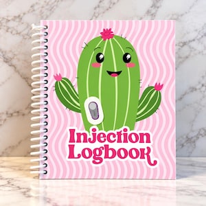 May include: A spiral-bound logbook with a pink and white wavy background. The cover features a green cartoon cactus with a smiling face, pink flowers, and a small medical device graphic. The text Injection Logbook is printed in bold pink.