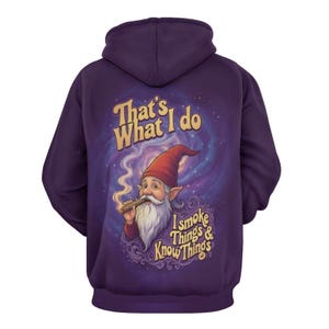 May include: A purple hoodie with a graphic of a smoking gnome with the text "That's What I Do, I Smoke Things & Know Things". The gnome wears a red hat and has a long white beard. The background is a swirling galaxy.