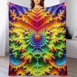 May include: A vibrant, colorful blanket with a fractal design. The blanket features a spectrum of colors, including purple, blue, green, yellow, orange, and red. The design is symmetrical, with a central heart-like shape and intricate, branching patterns.