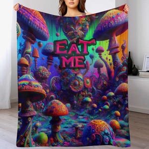 May include: A colorful blanket featuring a psychedelic mushroom forest design with the words "EAT ME" in pink. The blanket showcases a vibrant array of colors, including blues, purples, oranges, and greens, creating a whimsical and fantastical scene.