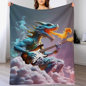 May include: A blue dragon playing an electric guitar, exhaling flames, on a blanket. The dragon is set against a cloudy, purple and blue background. The guitar has a white pickguard and a brown body.