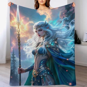 May include: A plush blanket featuring a fantasy illustration of a woman with long white hair, wearing blue armor and holding a spear. The artwork has a celestial background with clouds and a forest, creating a mystical theme.