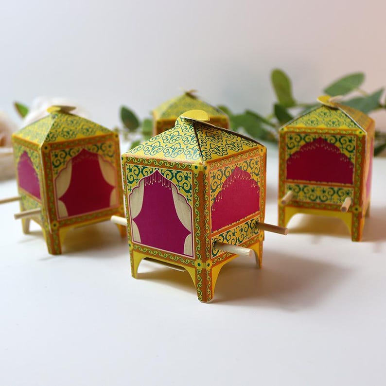 Three assembled doli boxes filled with colorful candies and almonds.