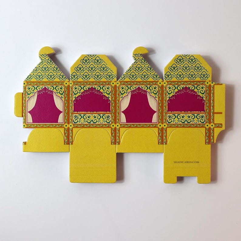 Flat pack sheet showing the doli-shaped favor box template before assembly.