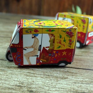 A pair of vibrant red rickshaw boxes on a gold tray, symbolizing good fortune and adding authentic Desi charm to your event.