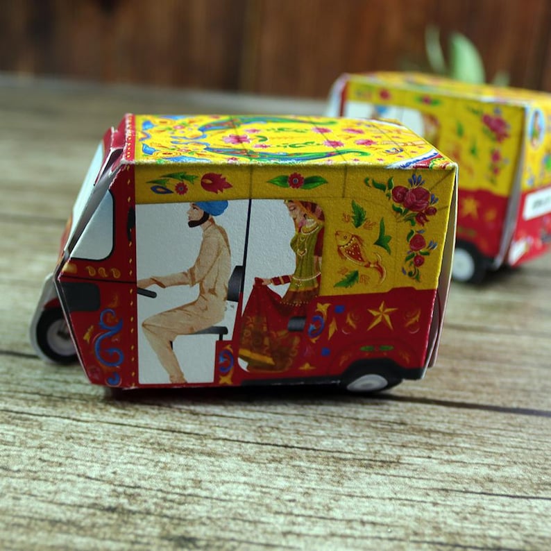 A pair of vibrant red rickshaw boxes on a gold tray, symbolizing good fortune and adding authentic Desi charm to your event.