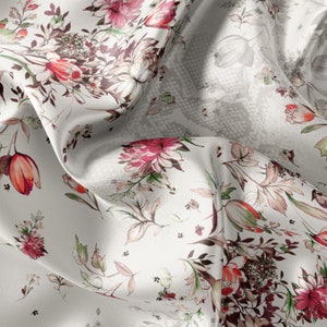 May include: White satin fabric with a floral print featuring red, pink, and green flowers. The fabric has a subtle textured pattern.
