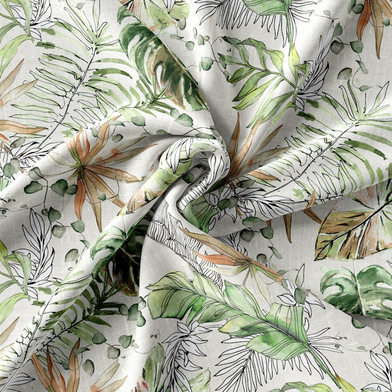 May include: A white fabric with a green, brown, and black tropical leaf pattern. The fabric is crumpled and has a textured surface.