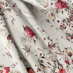 May include: White fabric with a floral pattern featuring red and pink flowers and green leaves. The fabric has a subtle snakeskin texture.
