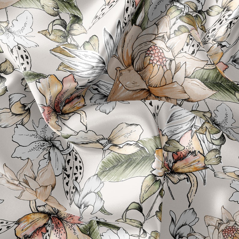 May include: A white fabric with a floral pattern. The flowers are drawn in shades of brown, pink, and green. The fabric has a soft, flowing texture.