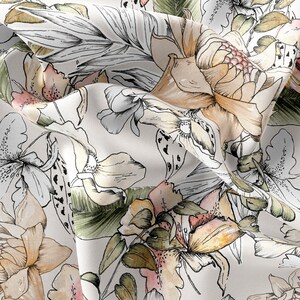 May include: A white fabric with a floral print featuring a variety of flowers in shades of pink, orange, and yellow. The flowers are drawn in a watercolor style with black outlines.