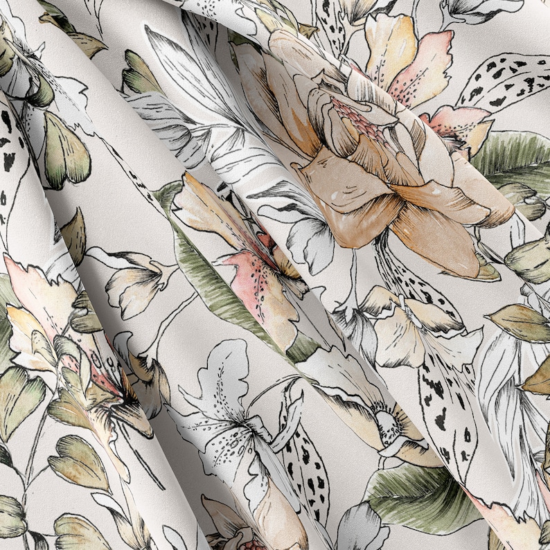May include: A white fabric with a floral pattern. The flowers are in shades of brown, pink, and green. The fabric has a soft, flowing texture.