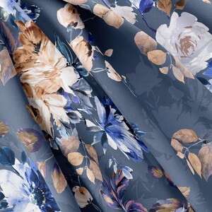May include: A blue fabric with a floral pattern. The flowers are in shades of brown, white, and blue. The fabric is soft and flowing.