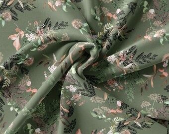 Puede incluir: Tela verde con un patrón floral con flores rosas y blancas y tallos negros. La tela está doblada y drapeada, mostrando el patrón.