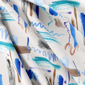 Op de afbeelding: Abstracte aquarel stof met een witte achtergrond en een patroon van blauwe, turquoise, bruine en paarse penseelstreken.