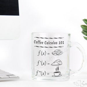 May include: A clear glass mug with a black design that says "Coffee Calculus 101" and includes a mathematical equation with coffee beans, a coffee cup, and a pastry.