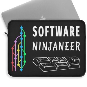 May include: Black laptop sleeve with the text "SOFTWARE NINJANEER" in white. The sleeve features a colorful graphic of a branching diagram and a keyboard outline. A silver laptop is partially visible.