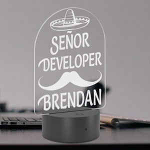 May include: A white acrylic night light with a sombrero, mustache, and the text "Señor Developer Brendan".