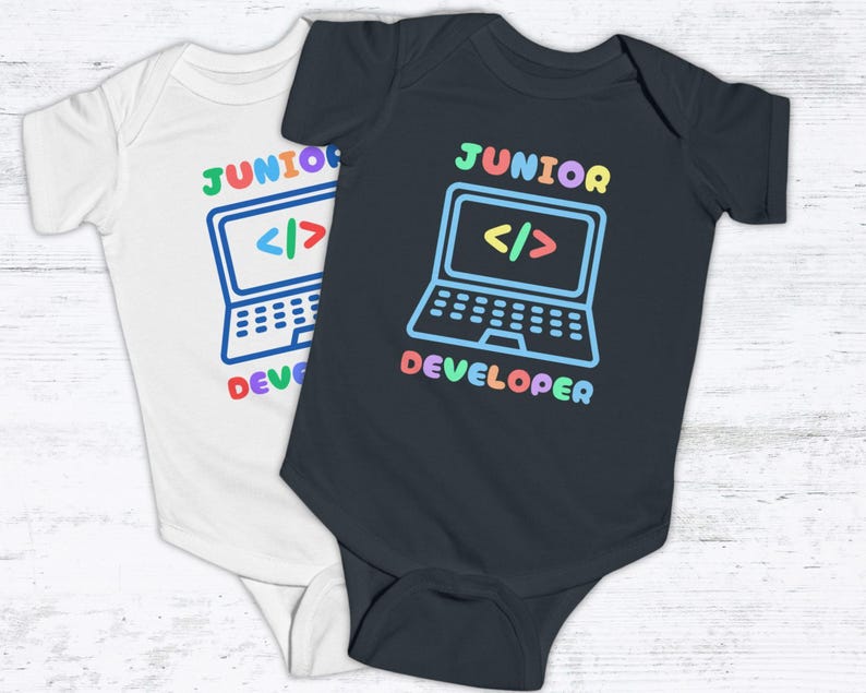 May include: Two baby onesies, one white and one black, with the text "Junior Developer" and a colorful cartoon laptop with code symbols on the screen.