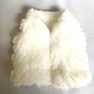 May include: A white faux fur vest with a zipper closure. The vest is made of soft, fluffy material and has a casual, relaxed style.