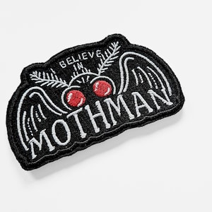 May include: Black embroidered patch featuring a mothman design. The mothman has large wings, red eyes, and the text "Believe in Mothman".